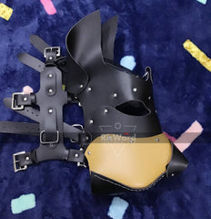 side view of leather pup mask placed on cloth surface with its adjustable belts 