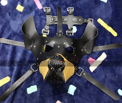 front view of leather pup mask placed on cloth surface with its adjustable belts 